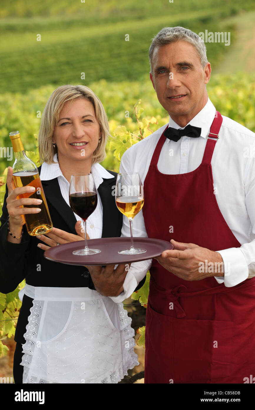 waiter and waitress serving wine Stock Photo Alamy