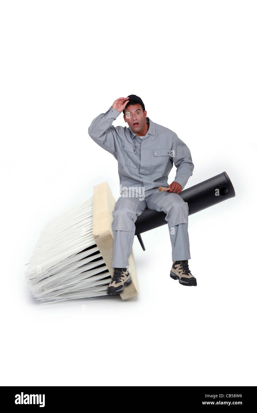 Speechless man sitting on a giant brush Stock Photo