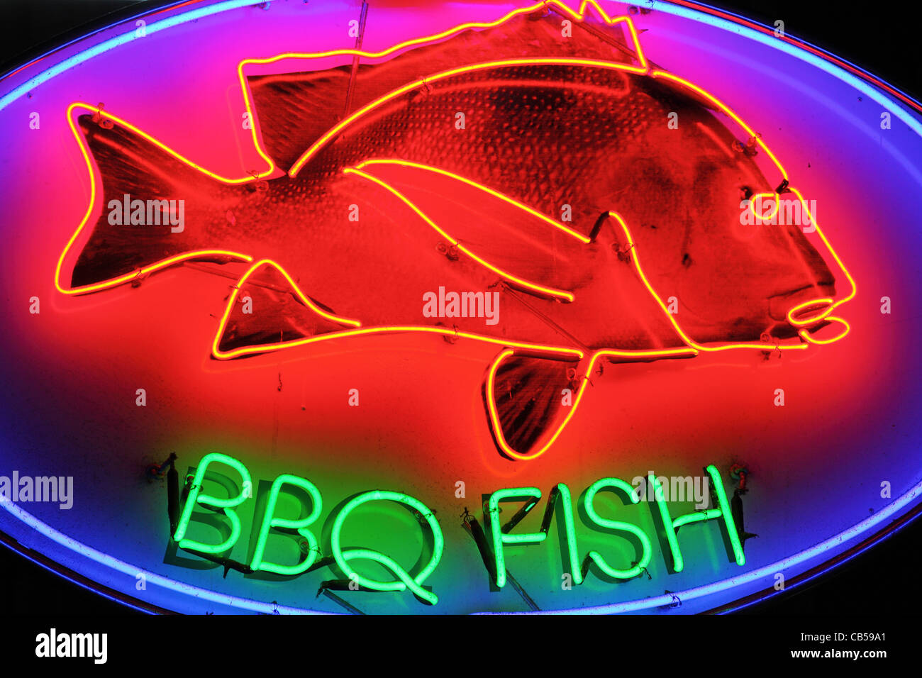 Neon BBQ fish sign at food court. Stock Photo