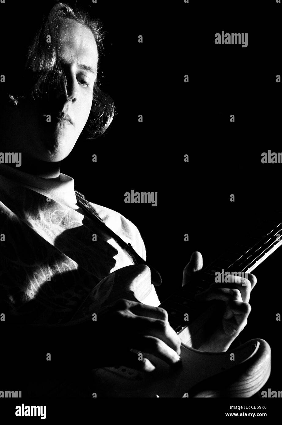 young guitar player on stage playing rock and roll Stock Photo