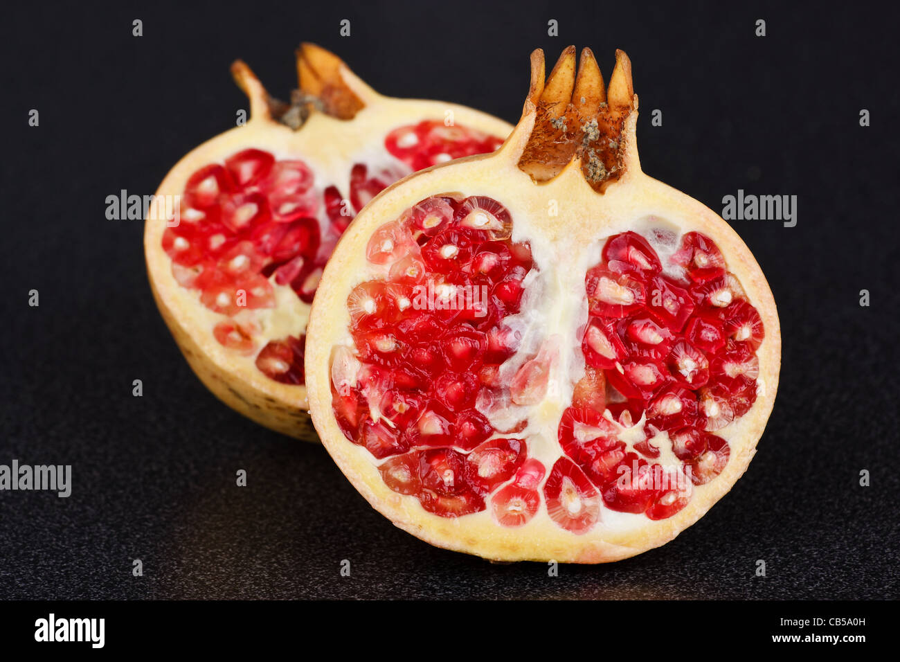 Pomegranate fruit - isolated over the black background Stock Photo