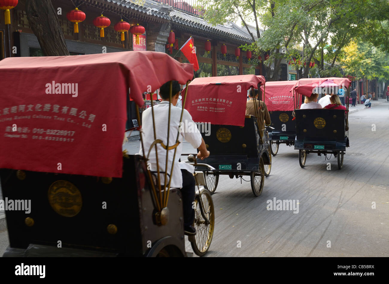 Pedicabs traffic on Qianhai Beiyan street in Shichahai area by Qianhai lake Beijing Peoples Republic of China Stock Photo