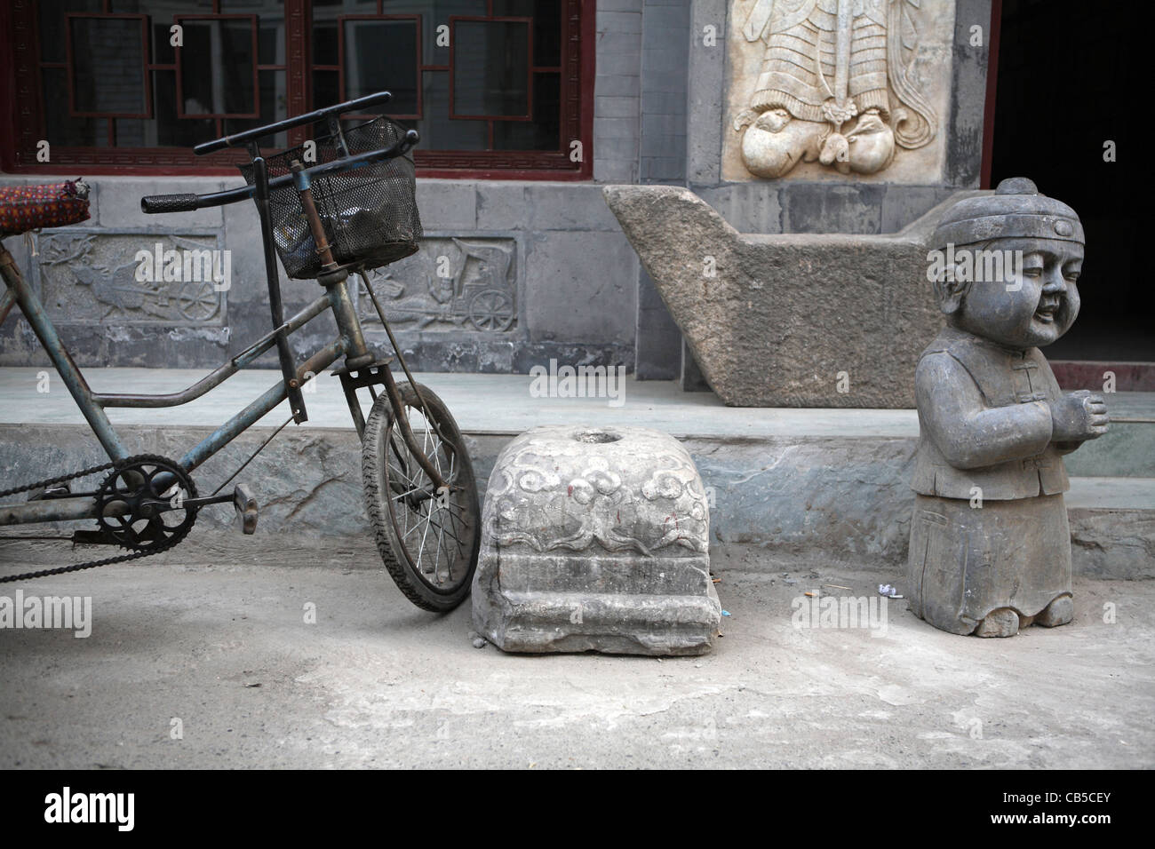 Hutong closeup still life, with tricycle & traditional Chinese statue, Beijing, China, Asia