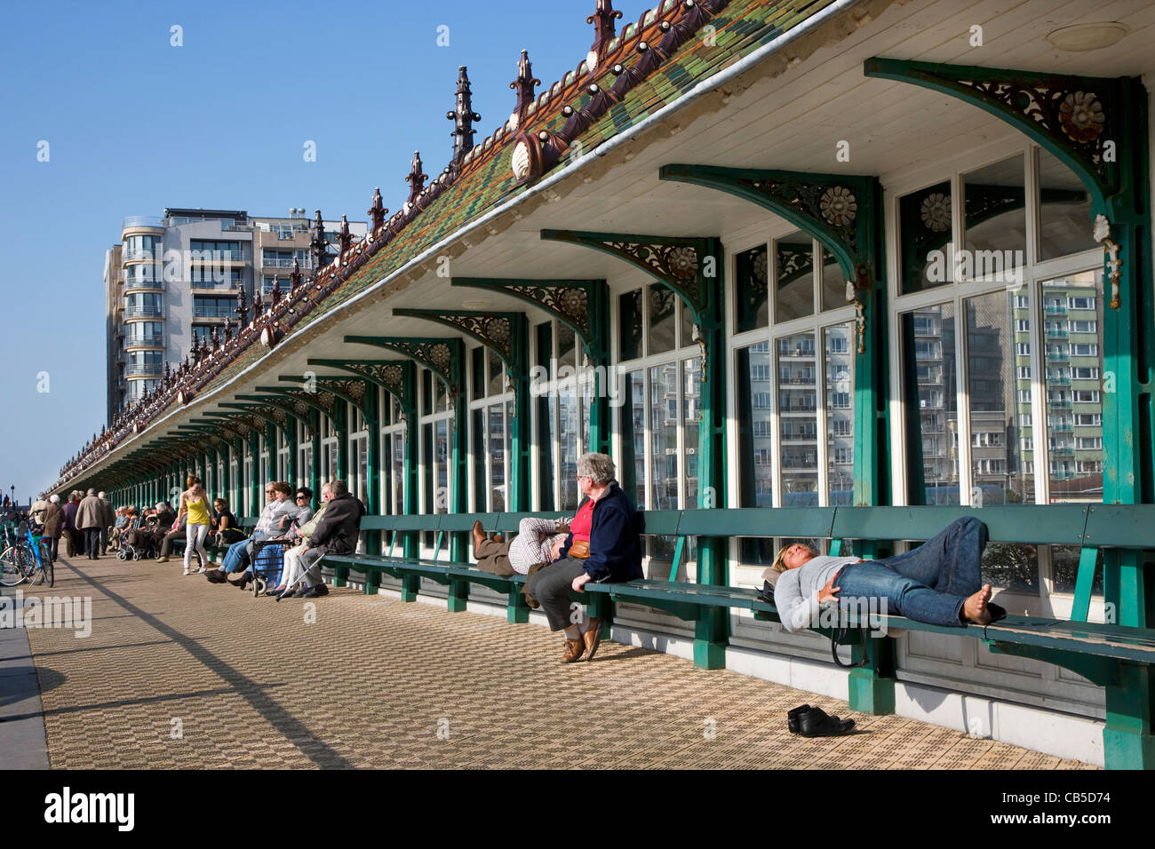 Tourists sunning under the Paravang, windscreen with benches at Blankenberge, Belgium Stock Photo