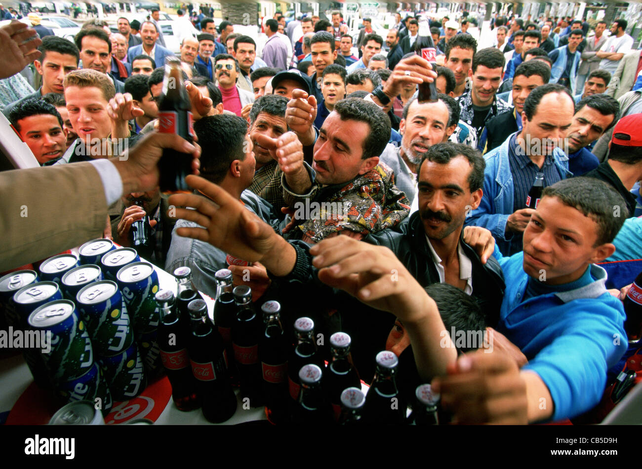 People drinking CocaCola being given away for free at a promotion