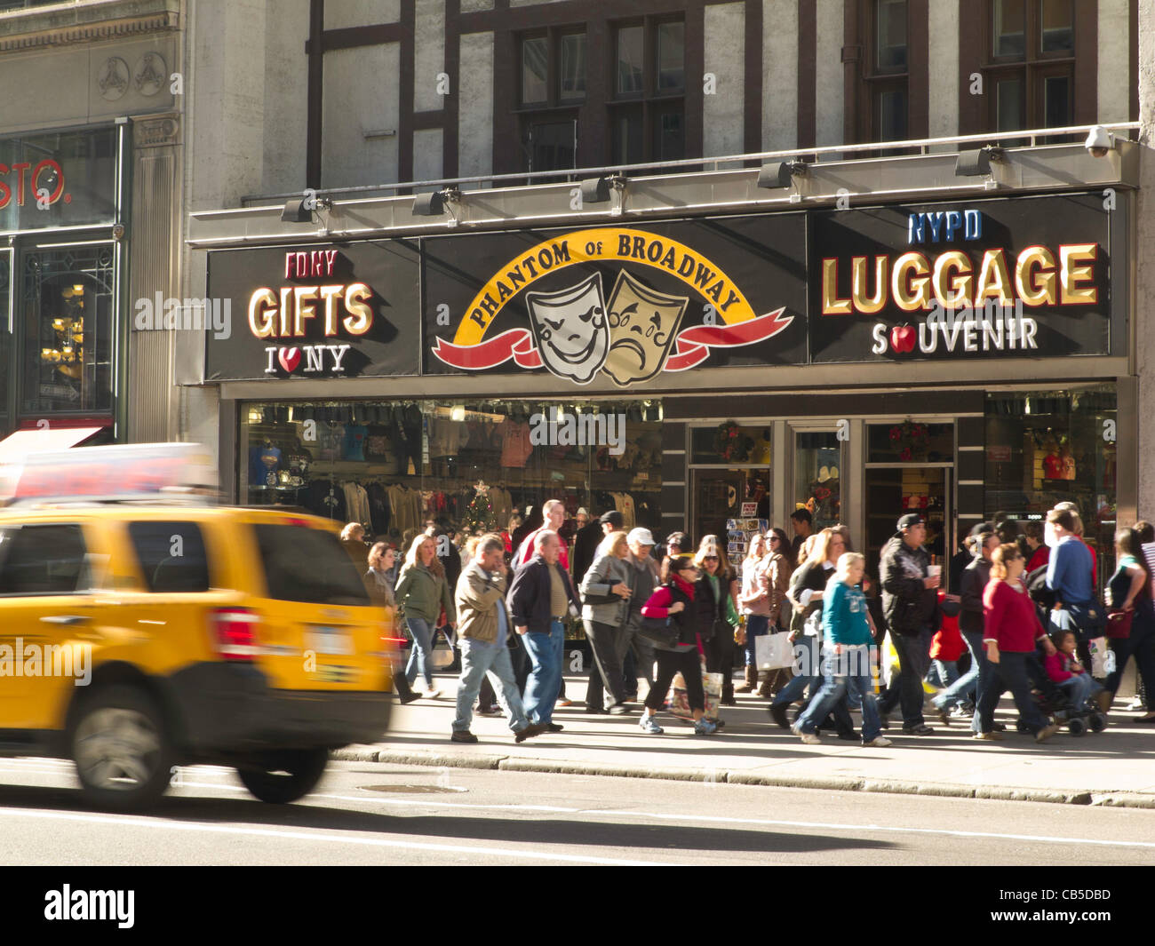 Tourists tourism traffic urban vehicle street storefront midtown