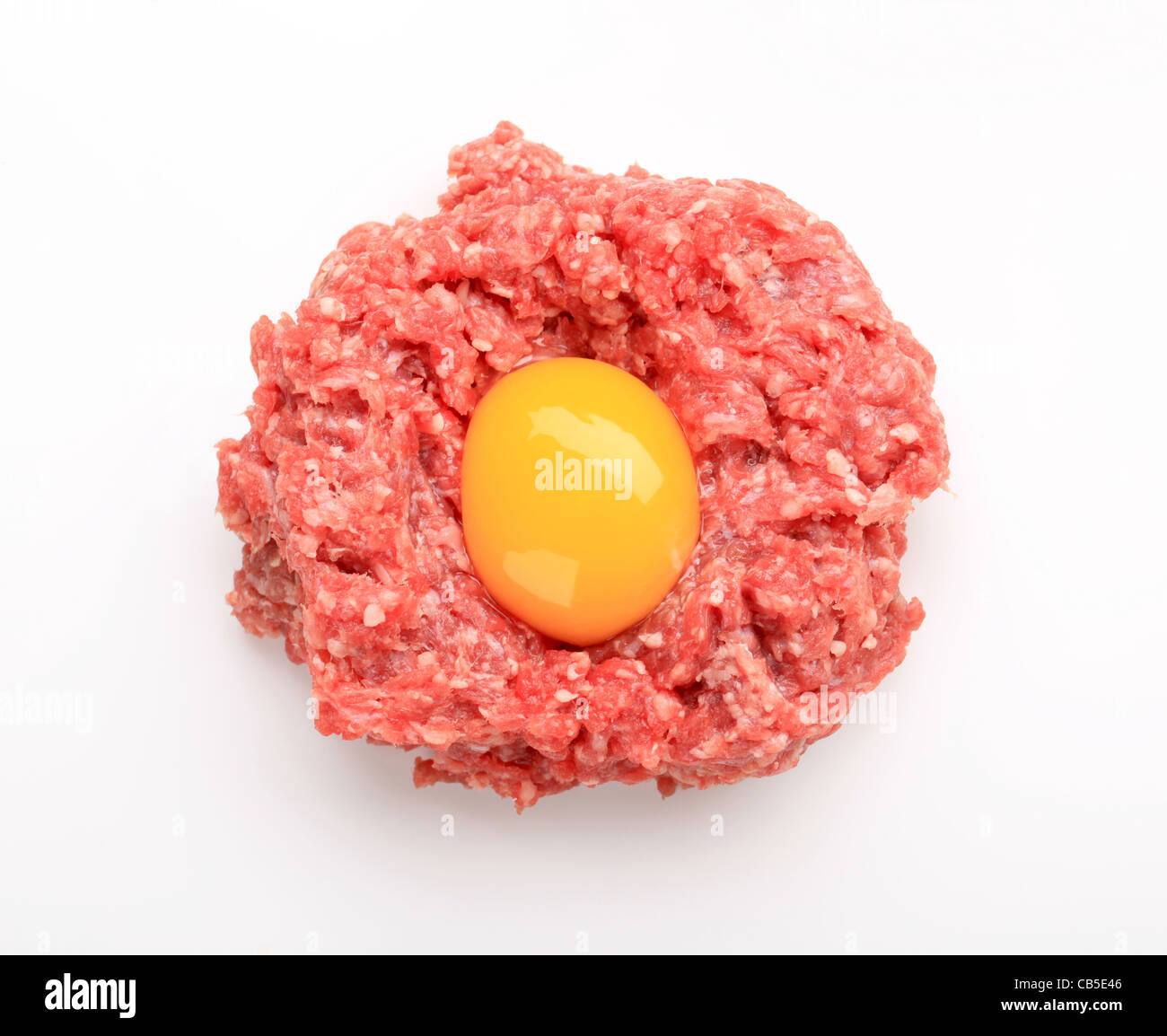 Raw ground meat and egg yolk studio Stock Photo Alamy