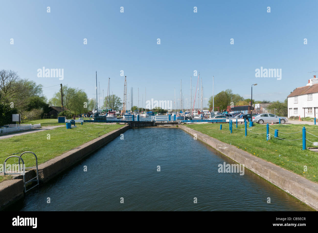 The lock at Heybridge Basin, Essex with boats moored in the basin in the distance. Stock Photo
