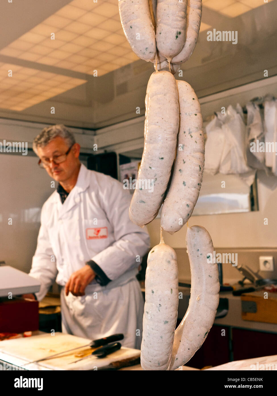 Butcher with string of pork sausages France Stock Photo Alamy