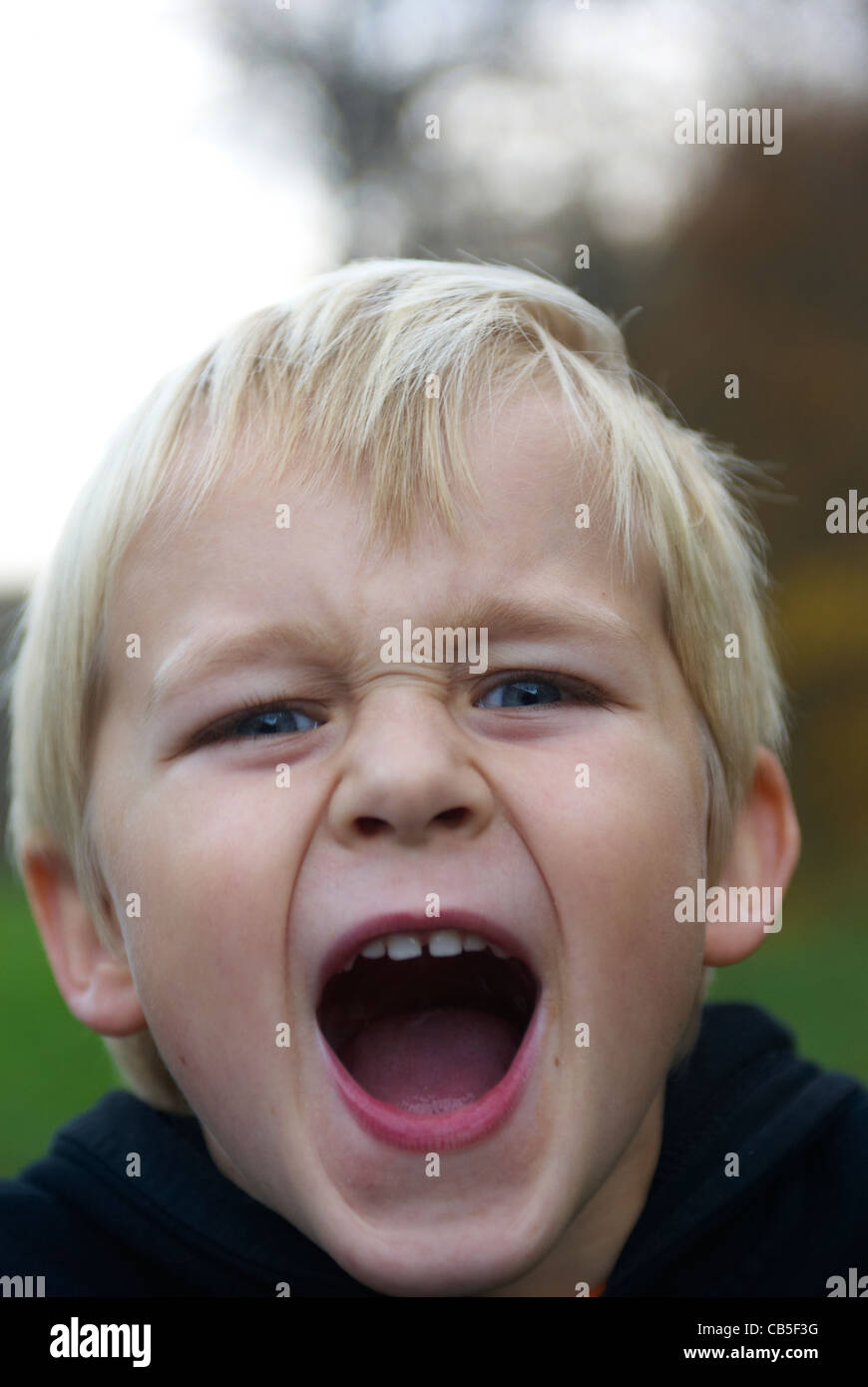 Close up portrait of blond boy making a face Stock Photo - Alamy