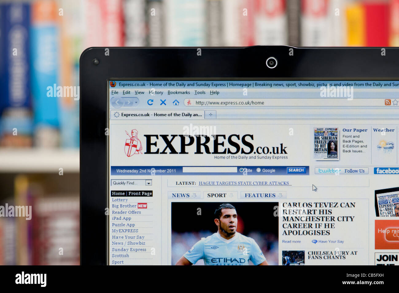 The Express newspaper website shot against a bookcase background (Editorial use only: ­print, TV, e-book and editorial website). Stock Photo