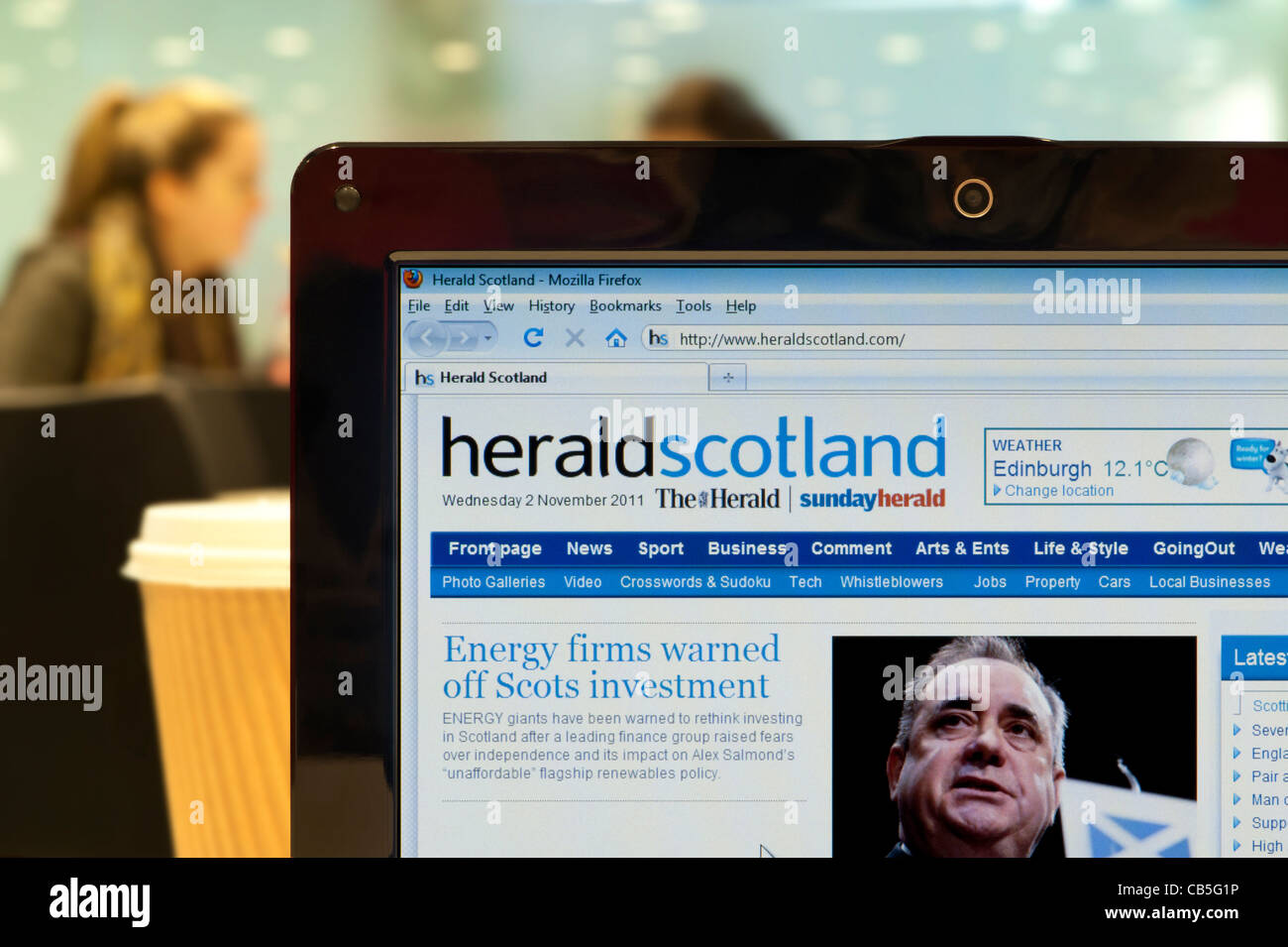 The Herald Scotland website shot in a coffee shop environment (Editorial use only: print, TV, e-book and editorial website). Stock Photo