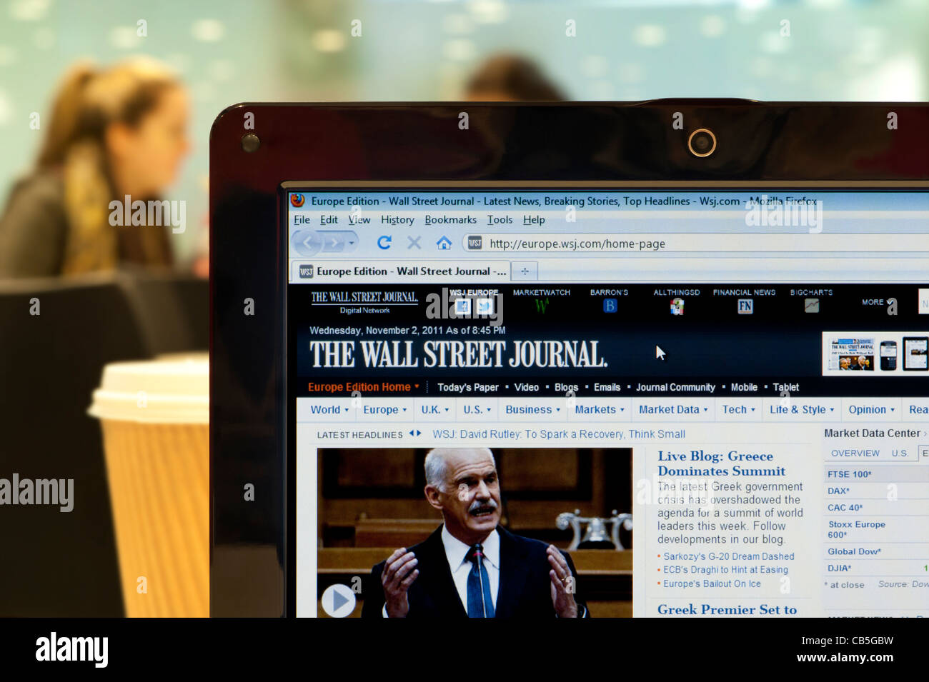 The Wall Street Journal website shot in a coffee shop environment (Editorial use only: print, TV,e-book and editorial website). Stock Photo