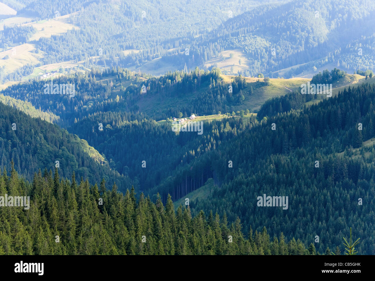 Summer mountain village landscape with hamlet on hill top Stock Photo