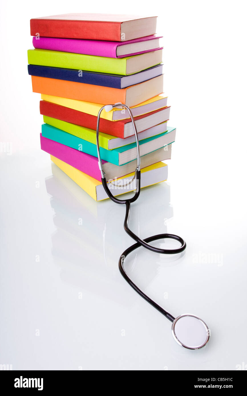 medical equipment and a stack of books isolated on white (selective ...