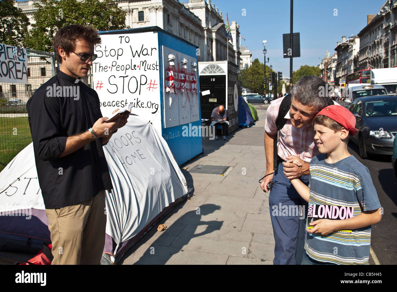 A man reads passages from the Bible, The Peace Camp, Parliament Square, London, England, Stock Photo