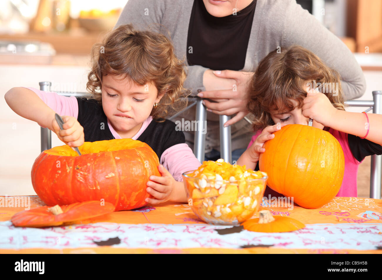 Children carving halloween pumpkins Stock Photo - Alamy