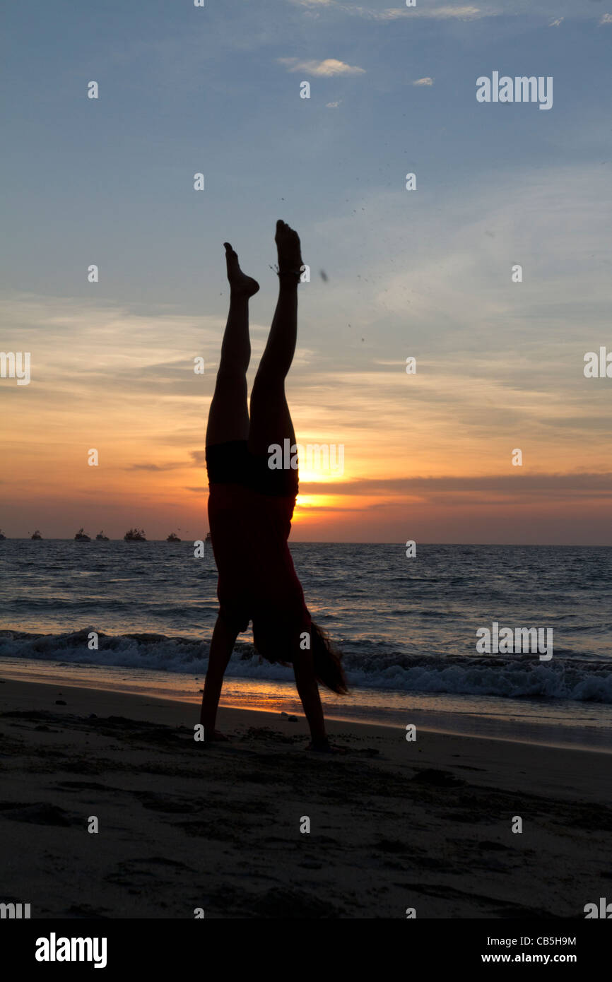 Silhouette of a girl doing a handstand on Mancora Beach, Peru Stock ...