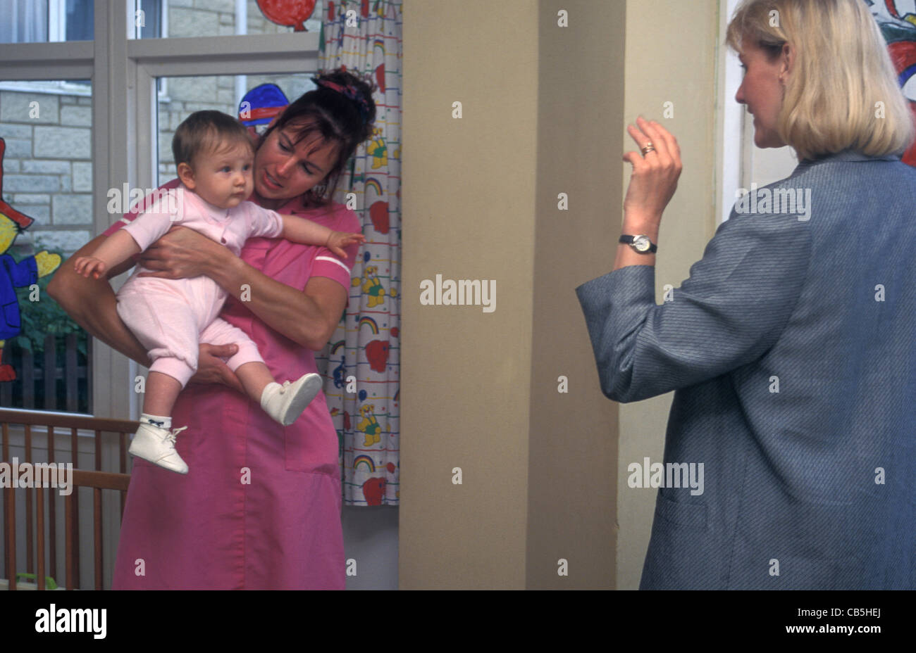 Working Mum Leaving Baby At Creche Stock Photo Alamy