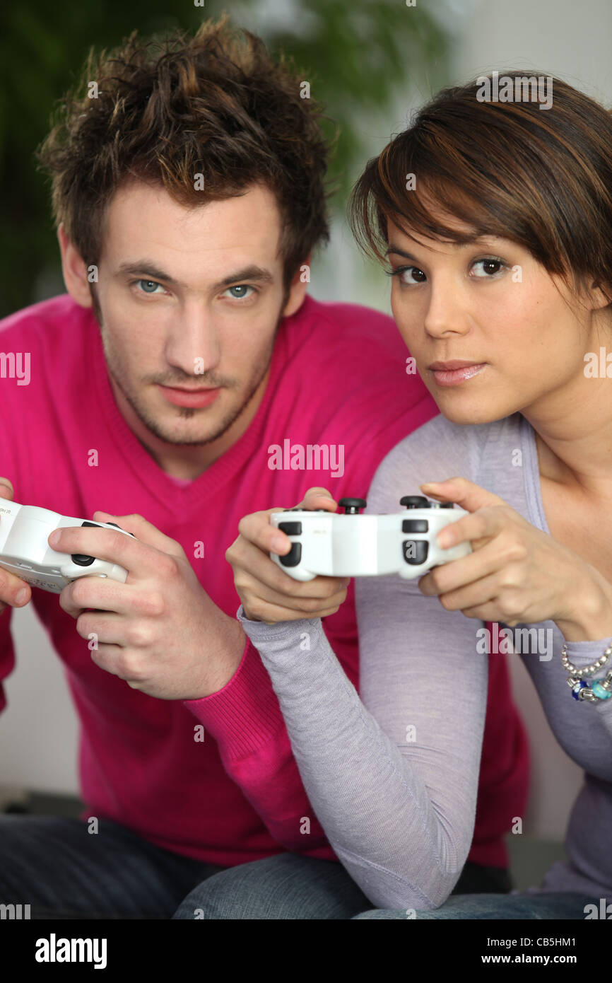 Man and woman playing video games Stock Photo - Alamy