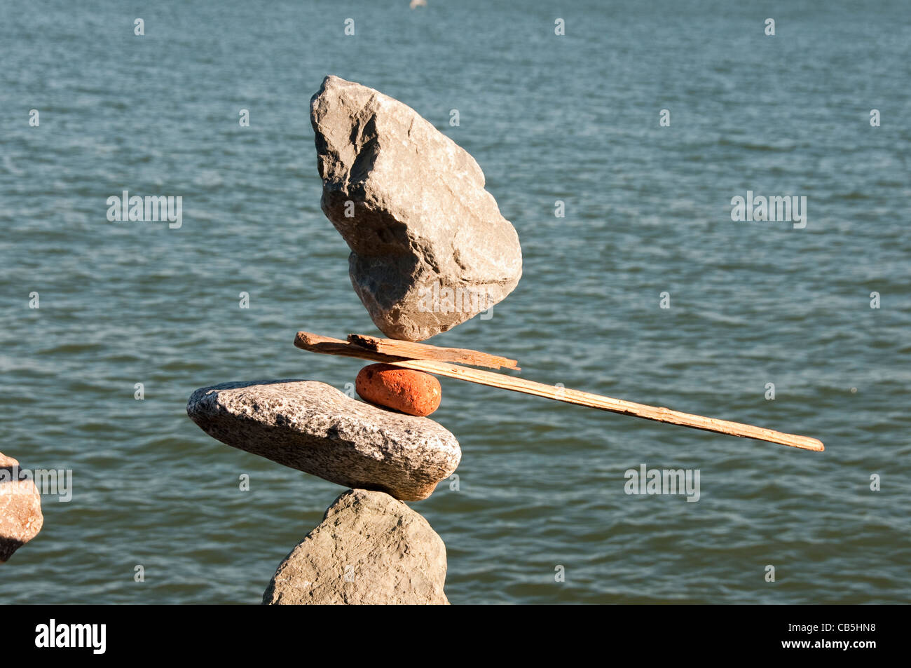 California Sausalito rock balance artist Bill Dan waterfront sculptor and his sculpture Stock Photo