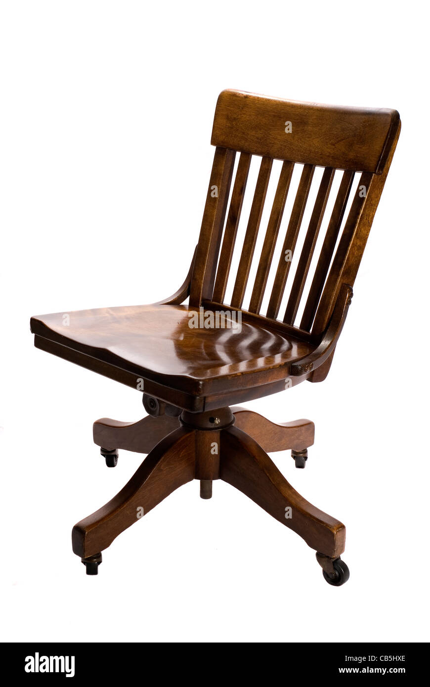 Antique oak swivel desk chair on wheels. Stock Photo