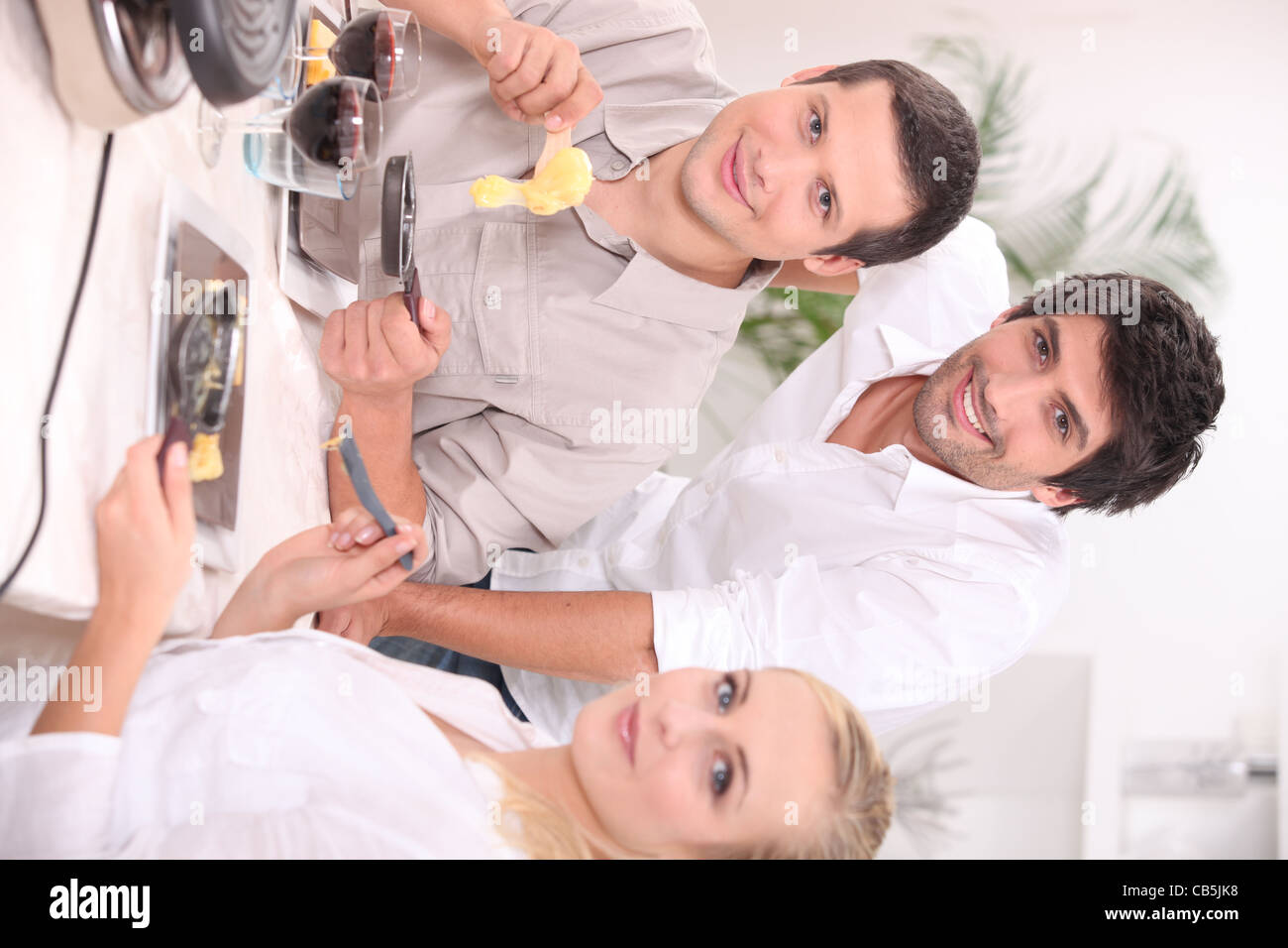 Friends eating raclette Stock Photo