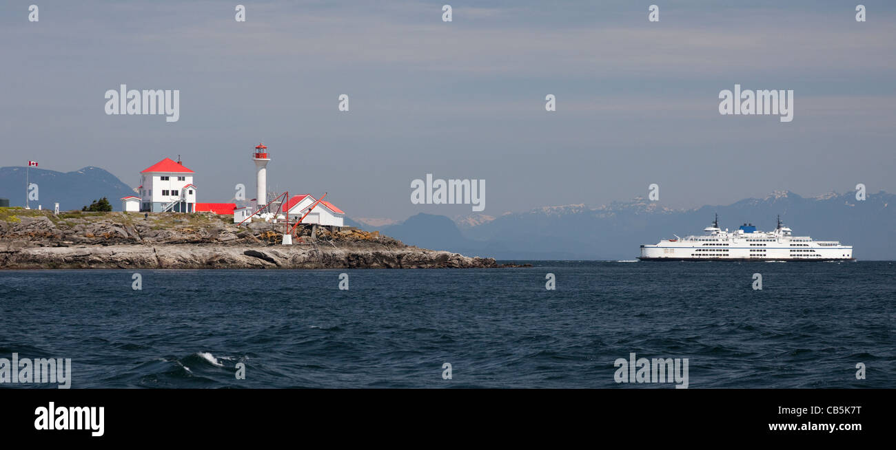 Ferry boat and Lighthouse on the rock Stock Photo