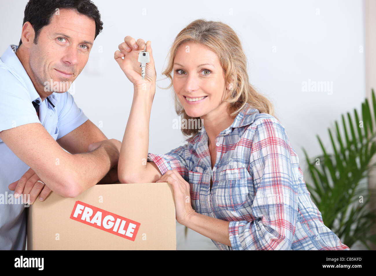 A couple moving in a new house Stock Photo - Alamy