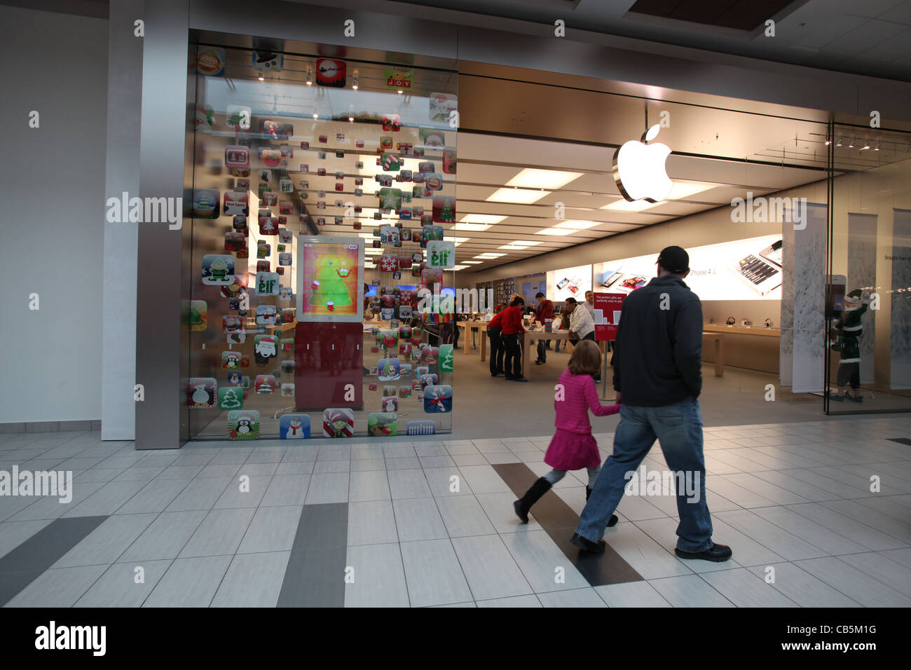 Father And Daughter Looking Into A Newly Opened Apple Store In
