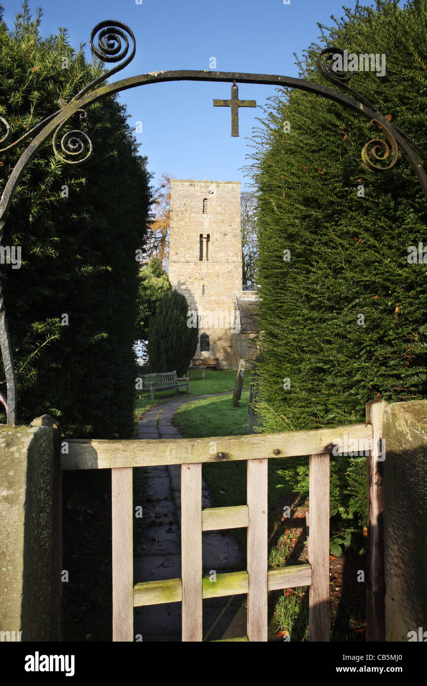 The Saxon tower of St. Andrew's church, Bolam, seen thro' church gate, near Morpeth, north east
