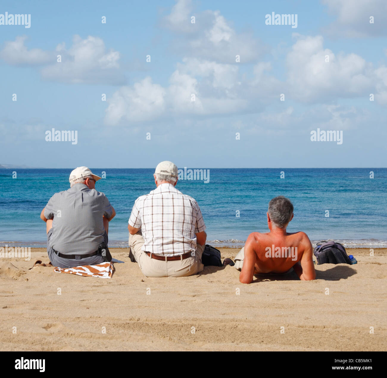 Three mature men on beach in Spain Stock Photo