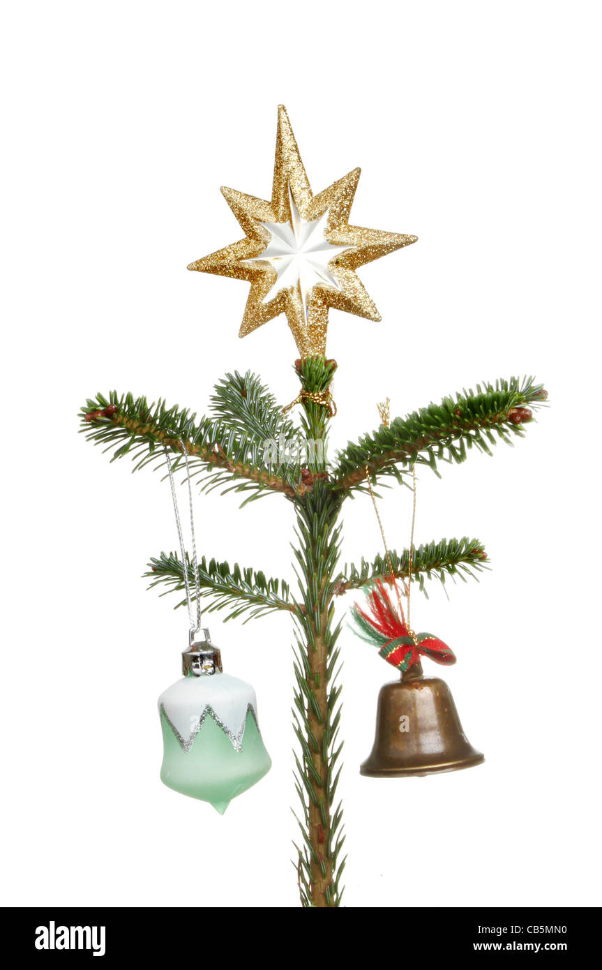 Top of a decorated Christmas tree with a gold star bauble and bell ...