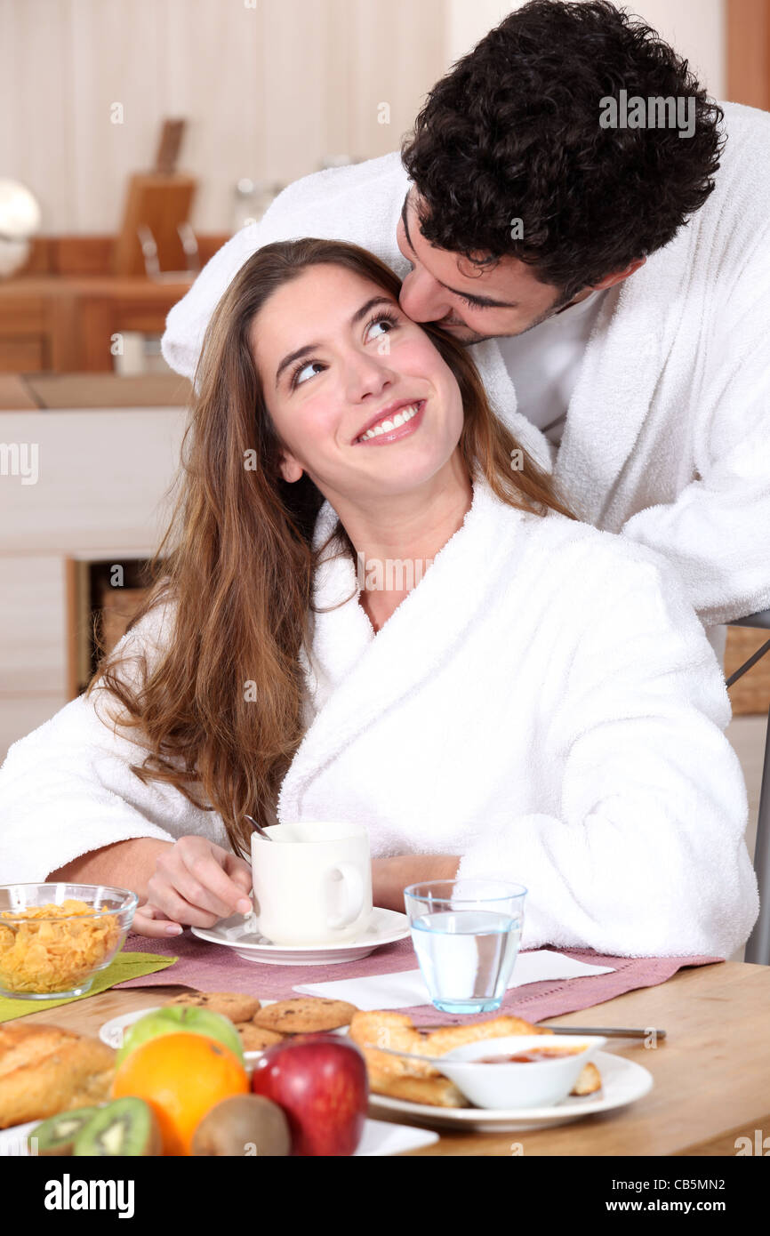 Couple wearing matching bathing robes in kitchen Stock Photo Alamy