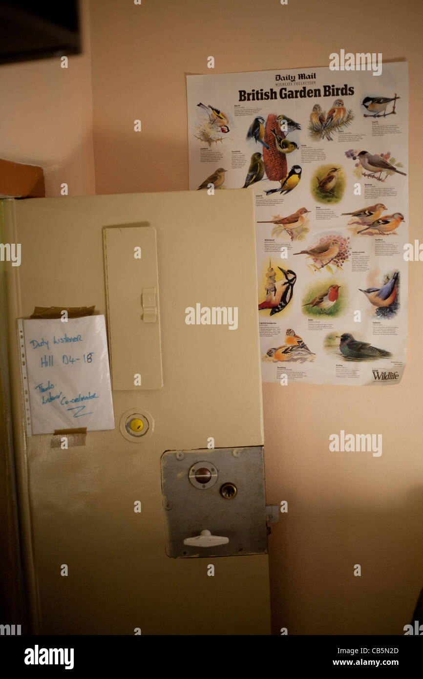 View of a cell door with poster of wild birds Birmingham Prison UK Stock Photo
