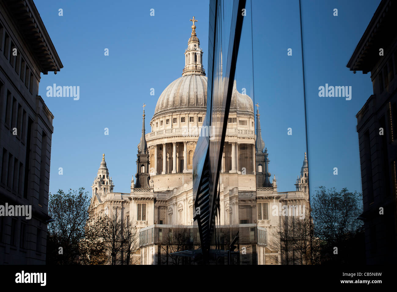 St. Paul’s Cathedral reflected in the glass walls of One New Change shopping centre Cheapside London Stock Photo