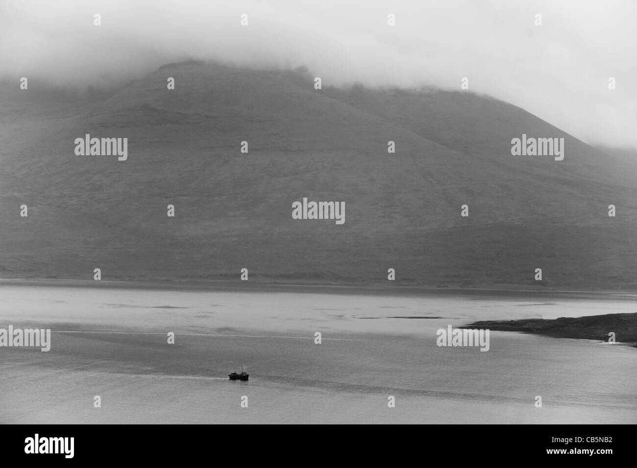 Lone fishing boat makes its way through Loch Na Keal, Isle of Mull, Scotland. Stock Photo