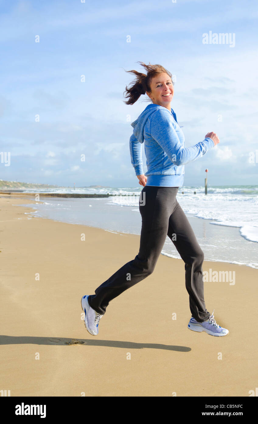 happy woman running on beach Stock Photo - Alamy