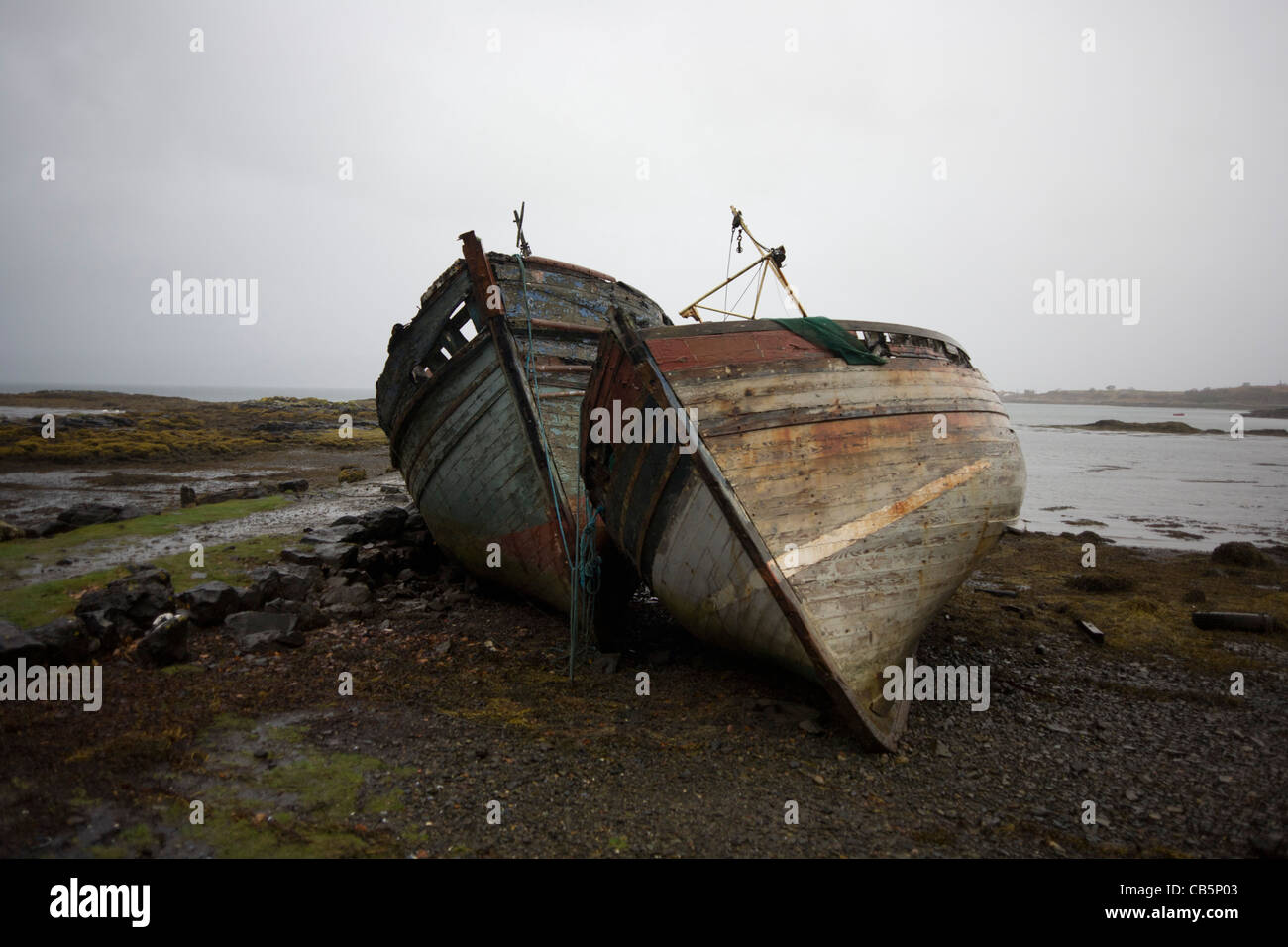 Wrecked fishing boats beached on shore at Salen, Isle of Mull. Stock Photo