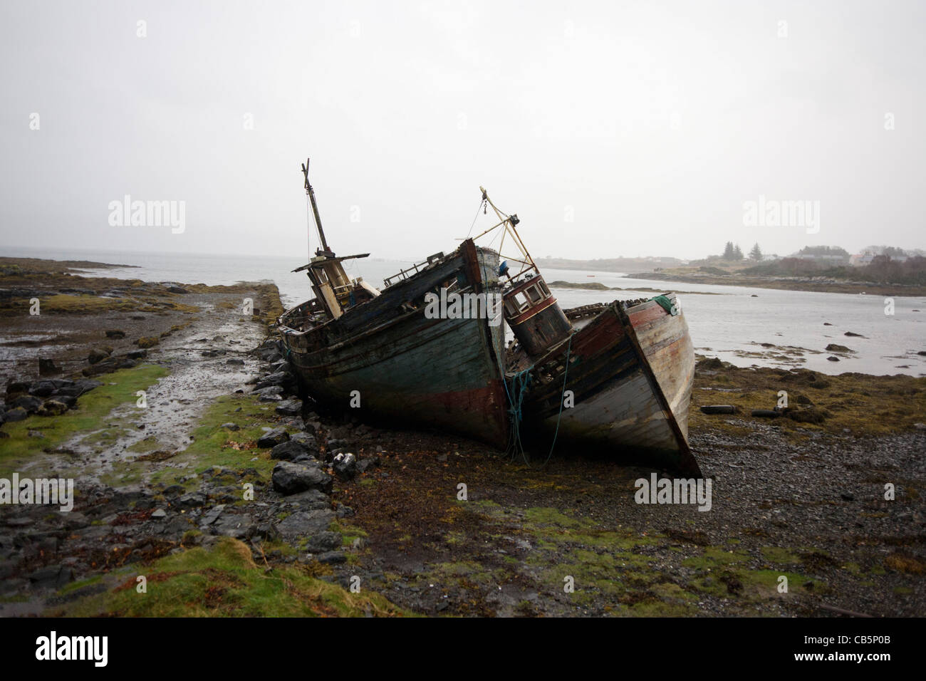Wrecked fishing boats beached on shore at Salen, Isle of Mull. Stock Photo