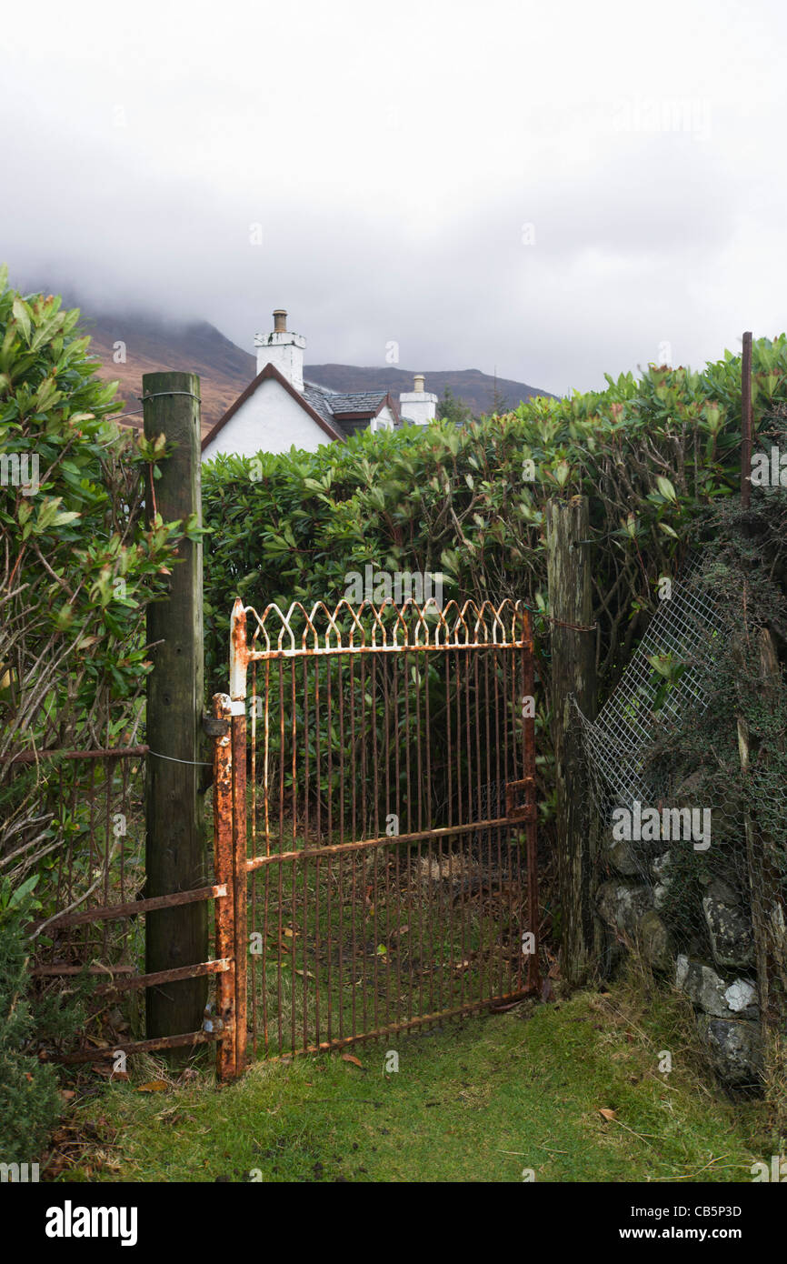 Rusting cottage gate at end of garden at Lochbuie, Isle of Mull, Scotland. Stock Photo