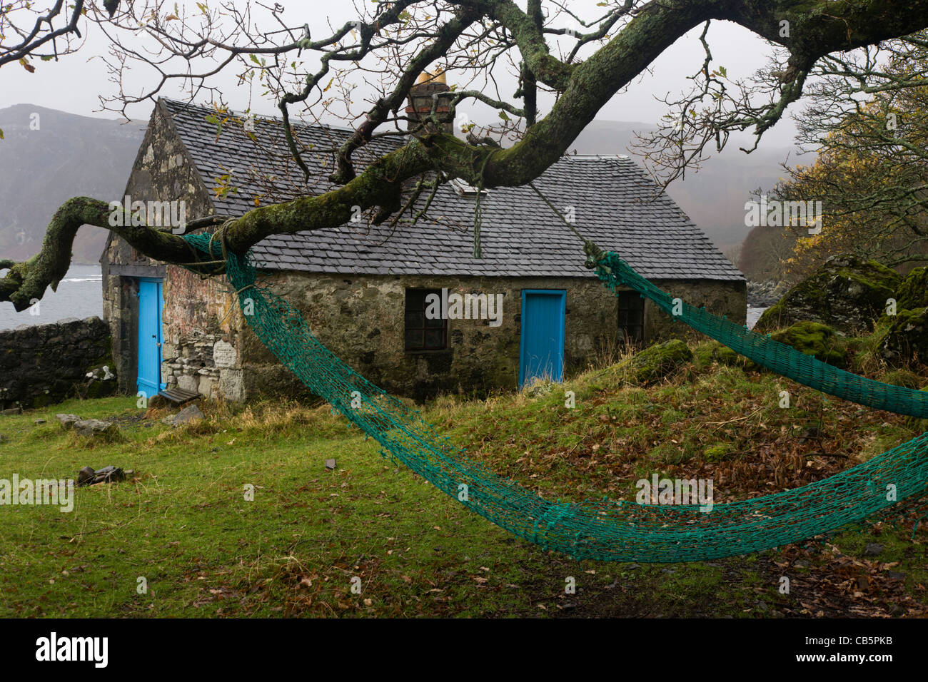 Old cottage and nets at Carsaig Bay fishing pier, Isle of Mull, Scotland. Stock Photo