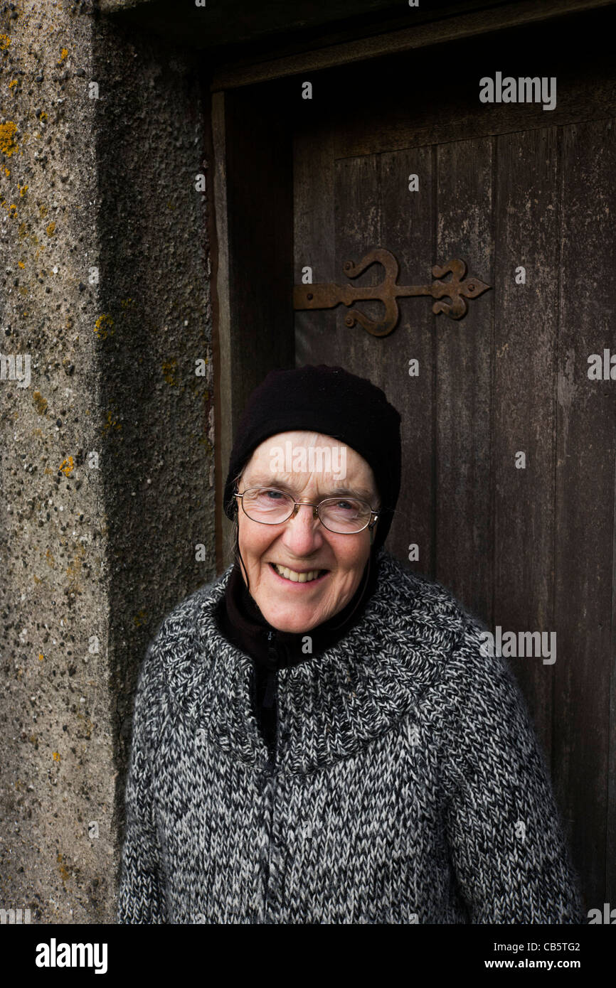 Portrait of caretaker Marina Carrier, at the doorway of the old church at Kilninian, Isle of Mull. Stock Photo