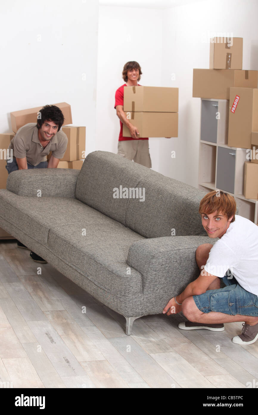 Young men moving home Stock Photo Alamy