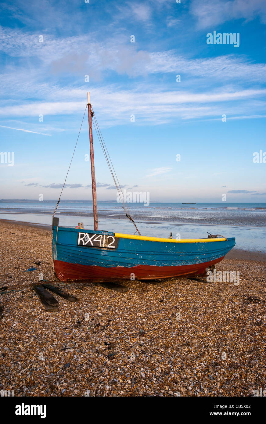 Blue Wooden Fishing Boat On The Beach at Littlestone Kent England UK Stock Photo