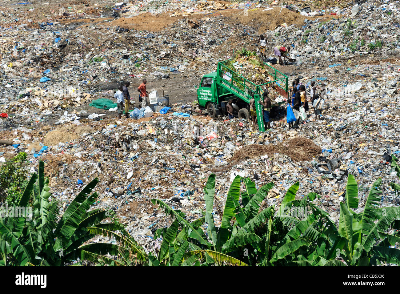 People working on a rubbish dump, collecting plastic and metal waste for recycling, Freetown, Sierra Leone. Stock Photo