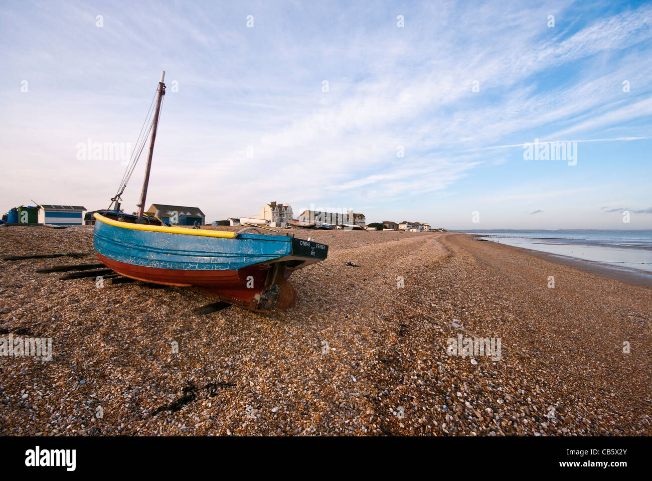 Blue Wooden Fishing Boat On The Beach at Littlestone Kent England UK Stock Photo