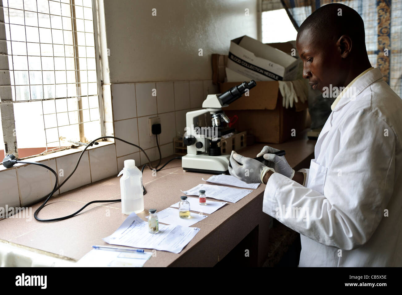 A laboratory technician in a hospital testing stool samples for