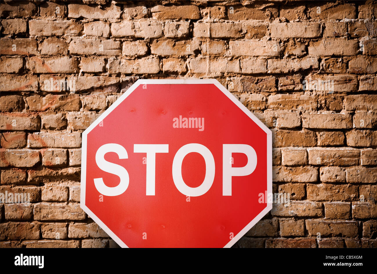 simple concept with red road sign and brick wall Stock Photo
