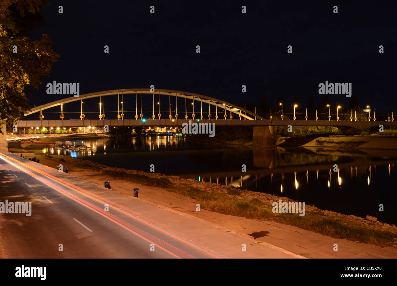 Long exposure night shot of the Belvárosi híd (Downtown Bridge) in Szeged, Hungary, above the river Tisza. Stock Photo